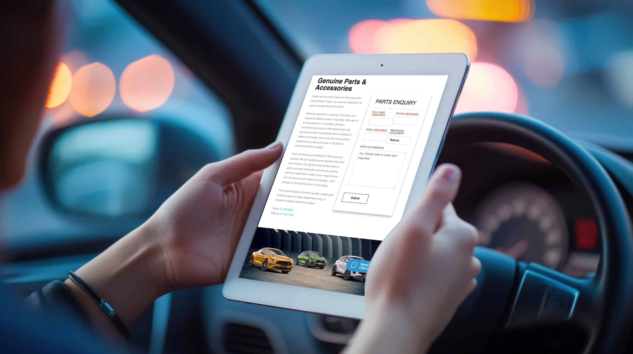 Person sitting in a car holding a tablet displaying a "Genuine Parts & Accessories" enquiry form on a website, with images of Ford vehicles at the bottom of the screen.