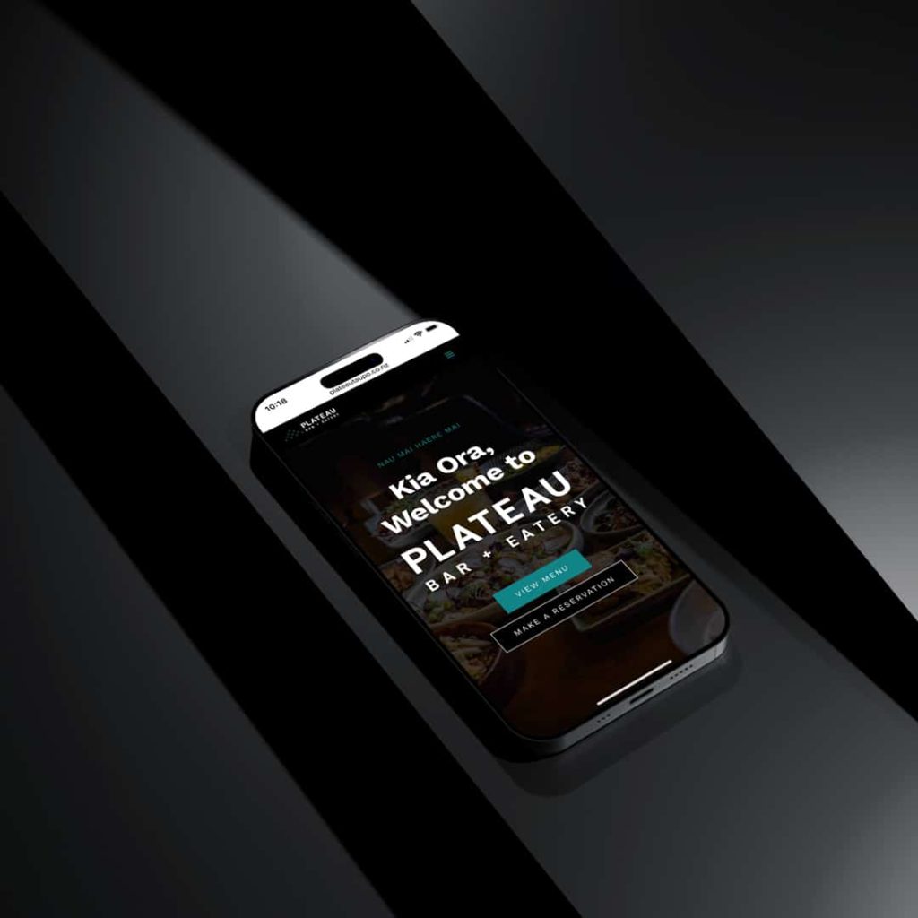 Smartphone displaying Plateau Bar + Eatery website with welcome message 'Kia Ora, Welcome to Plateau Bar + Eatery' and options to view menu or make a reservation.