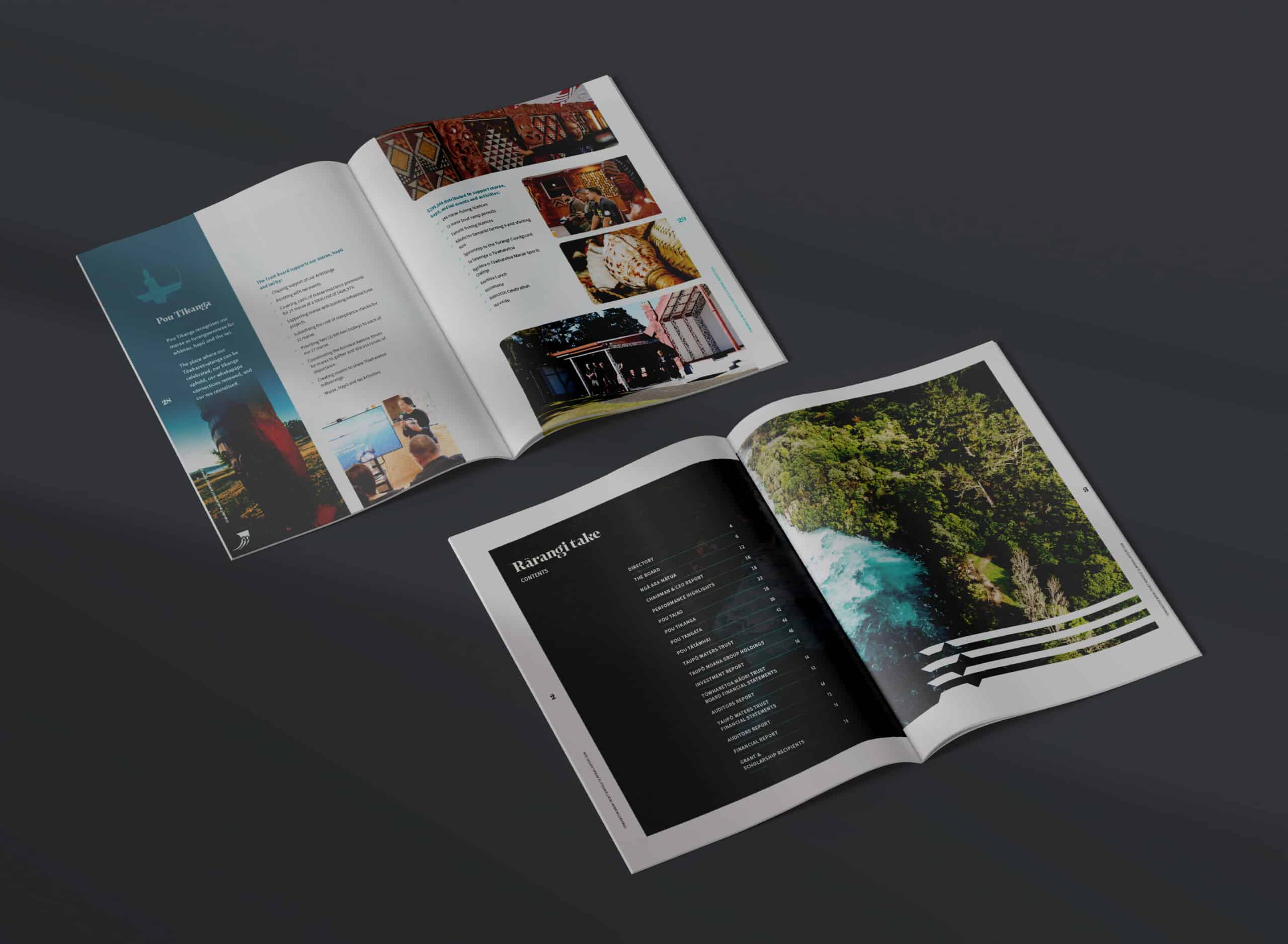 Two open annual report booklets displayed on a dark surface. The top booklet features a page spread with the title 'Pou Tikanga', text, and multiple photographs showcasing cultural patterns, carvings, and a marae building. The bottom booklet shows a contents page titled 'Rarangi Take' on a black background alongside a full-page aerial photograph of lush green forest and a river.