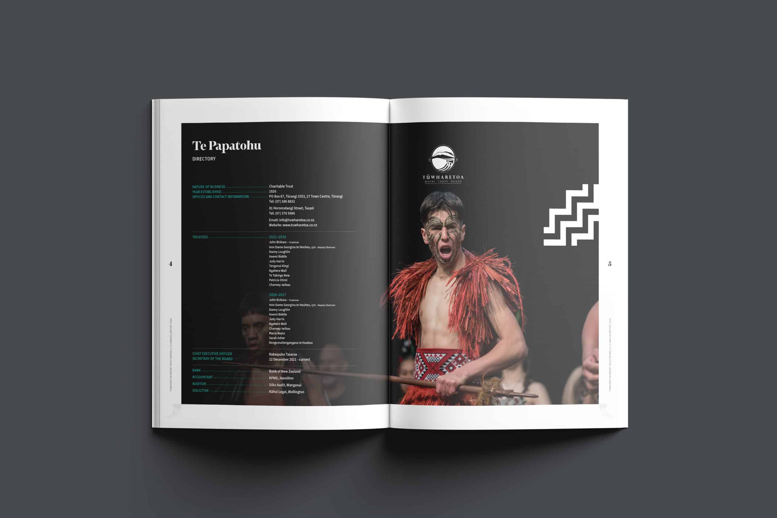 Open annual report showing a directory page on the left with trustee names, contact details, and organisational information under the title “Te Papatōhu.” On the right page, a large photo of a Māori performer in traditional attire with facial moko, wearing a red piupiu and holding a taiaha, appears against a dark background with the Tūwharetoa logo and a white geometric pattern.