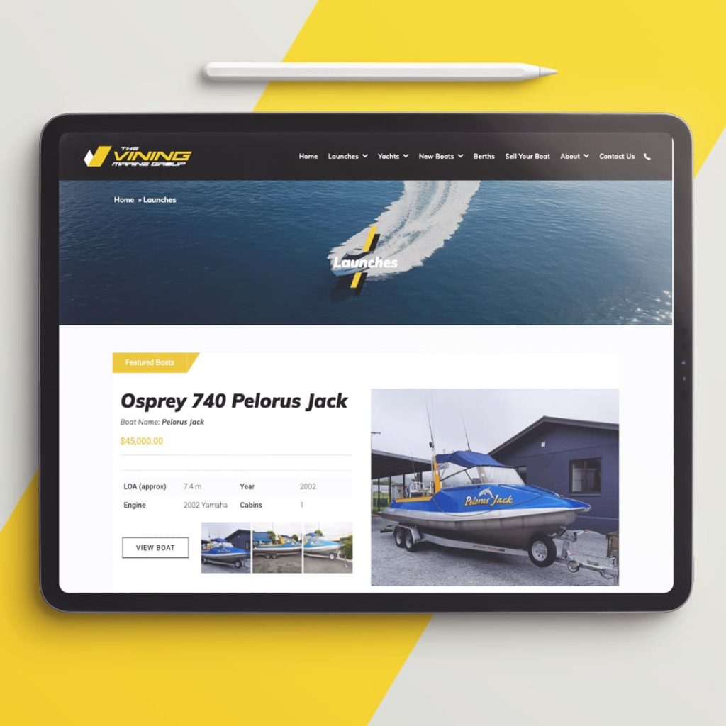 Tablet displaying the Vining Marine Group website's product page for the Osprey 740 Pelorus Jack boat, showing specifications, price, and multiple images of the vessel on a trailer, with a stylus resting above the device and a yellow-and-white background.